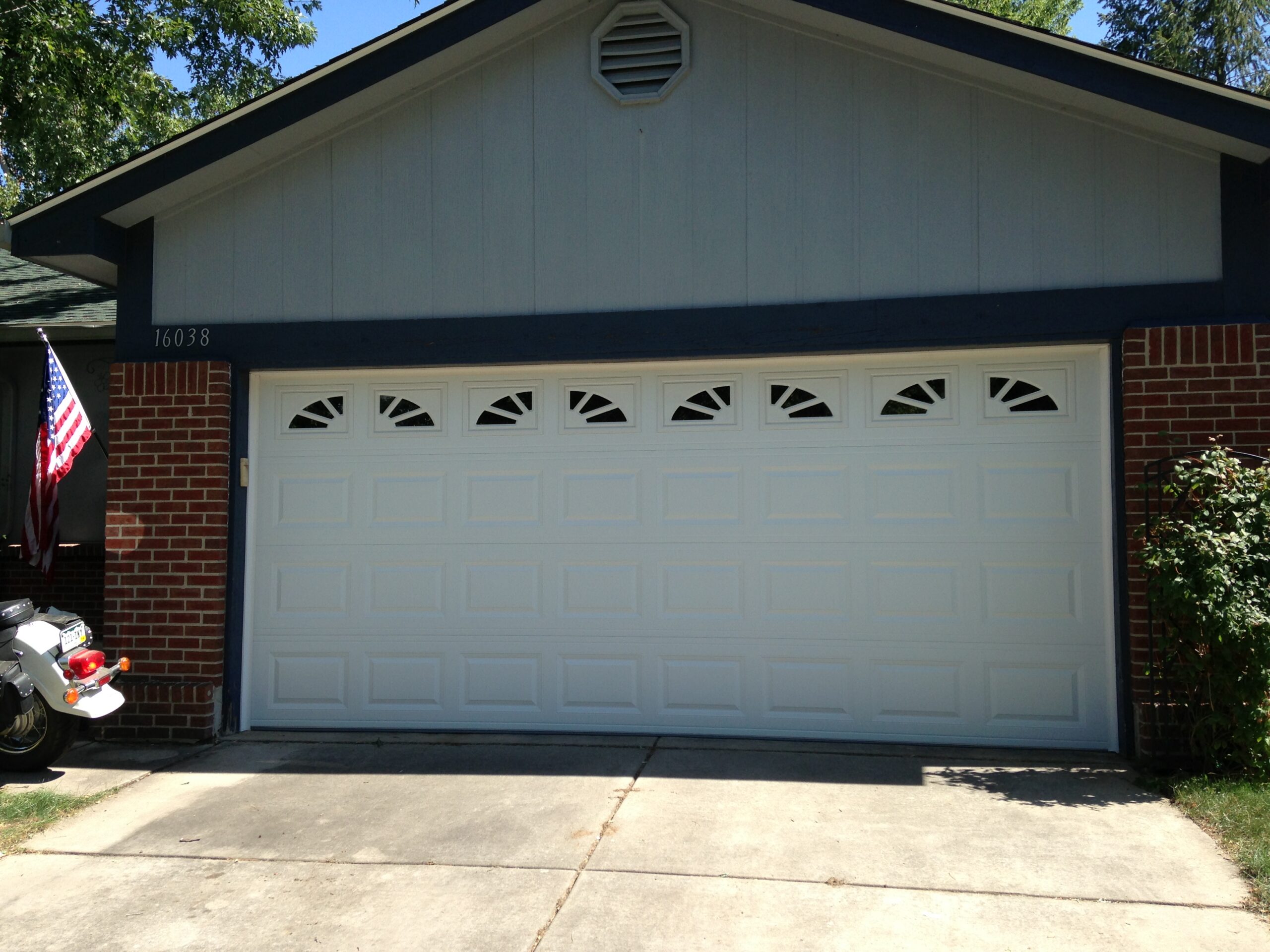 After: Modern Raised Panel Garage Door Replacement with Decorative Arch Windows