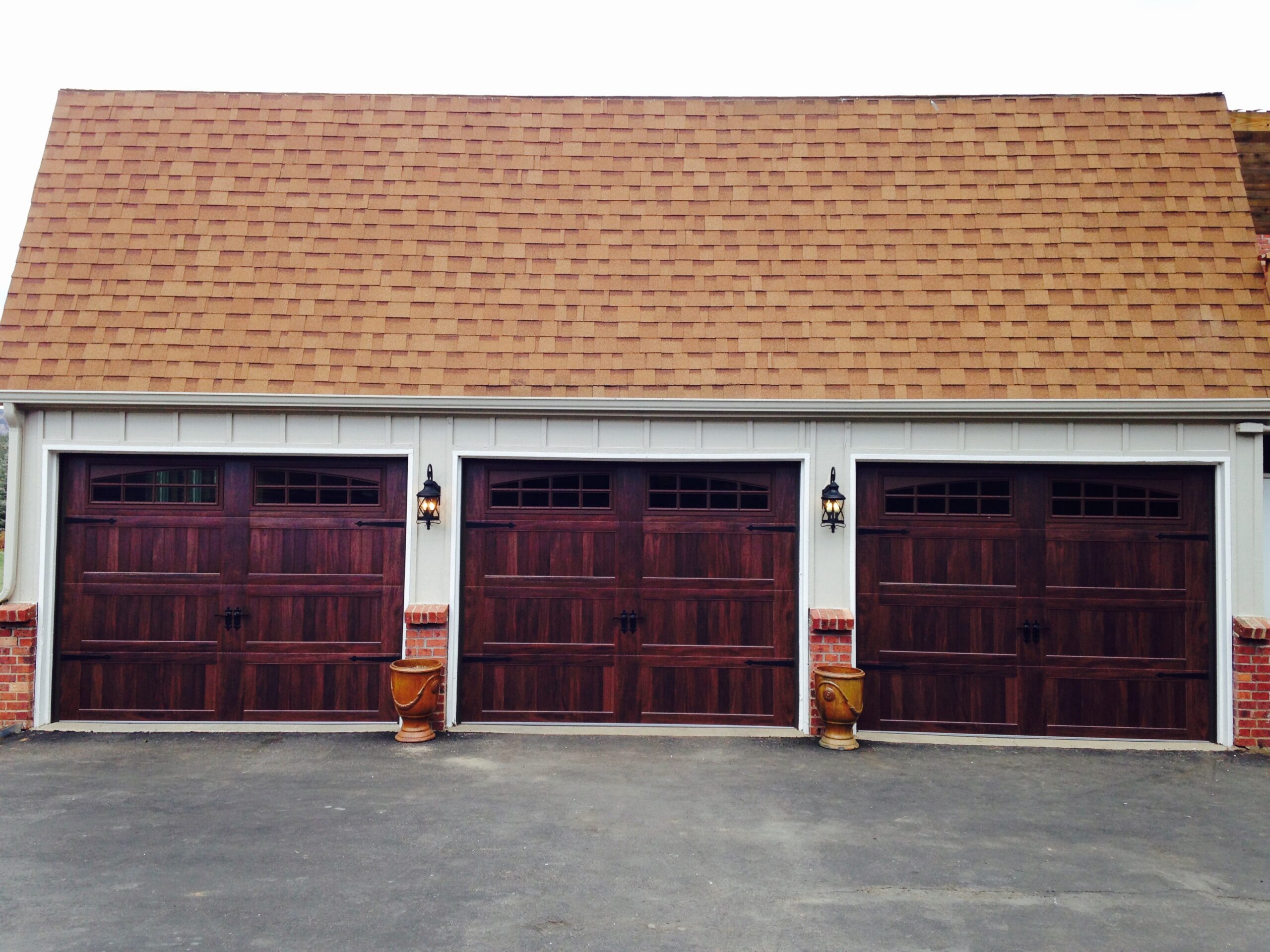 After: Triple Carriage House Garage Door Transformation with Arch Prairie Windows on Traditional Carriage-Style Garage