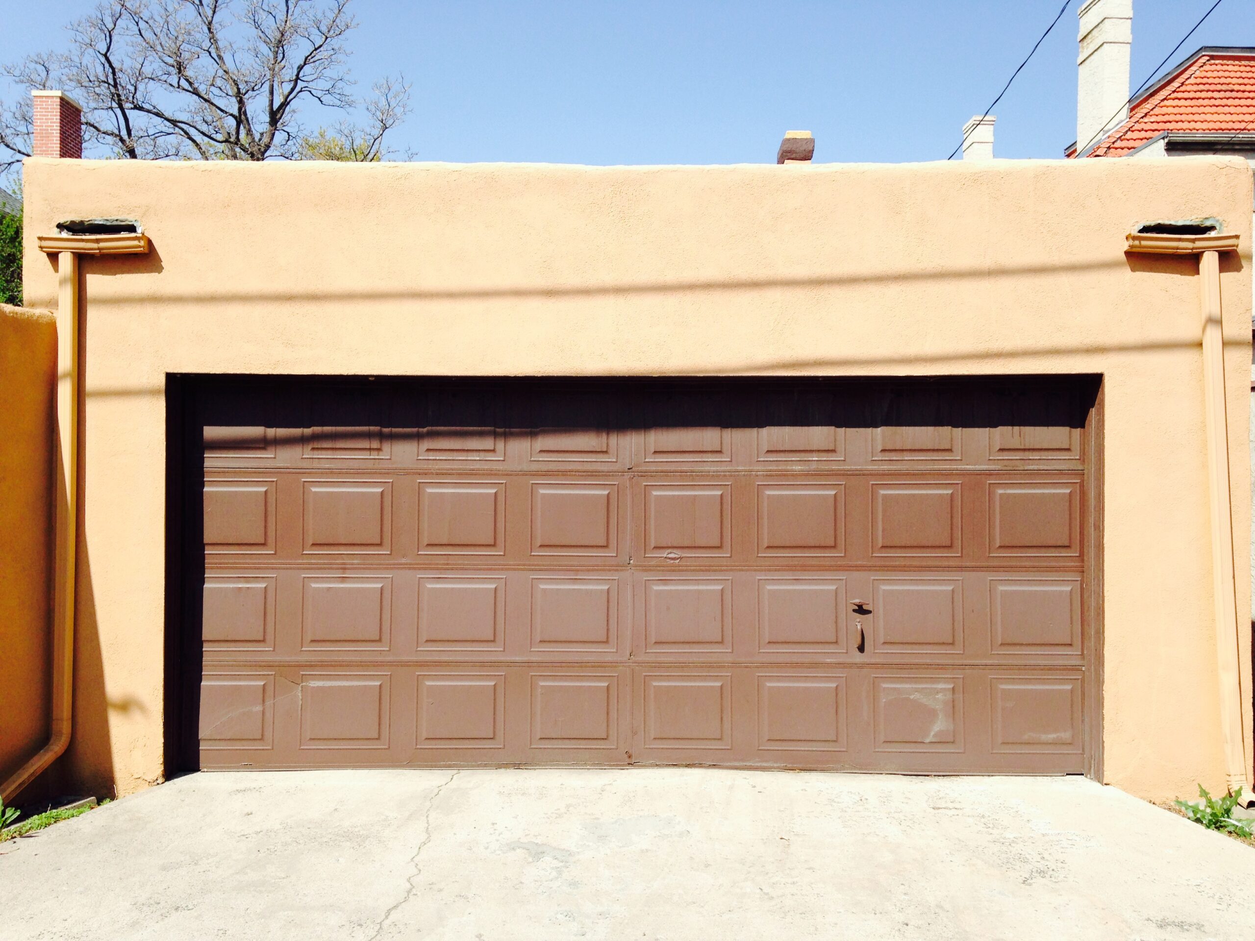 Before: Old damaged garage door